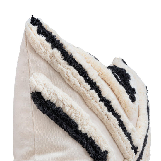 close up of renctangle boho cushion cover with black and white stings