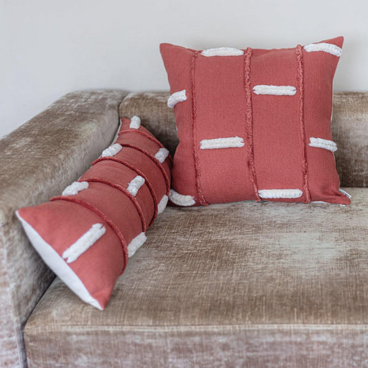 Red Bohe style rectangle and square  pillow covers on living room couch