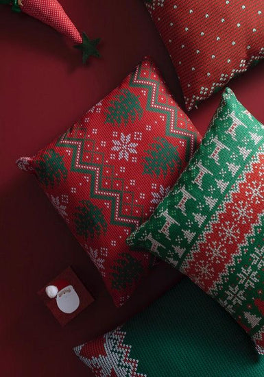 Holiday inspired pillow cover in red with pine trees and snowflakes