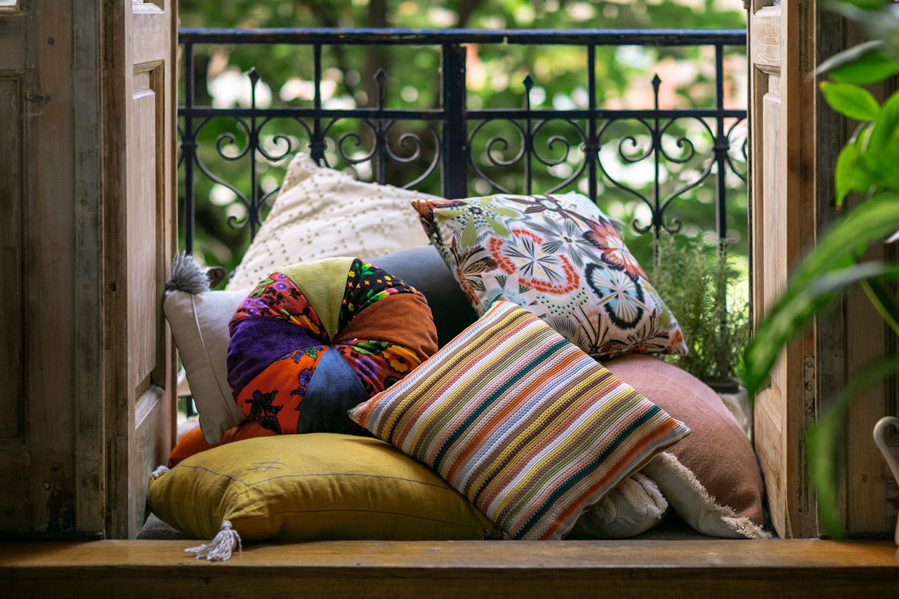 Decorative Throw Pillows Stacked ontop of each other on balcony 