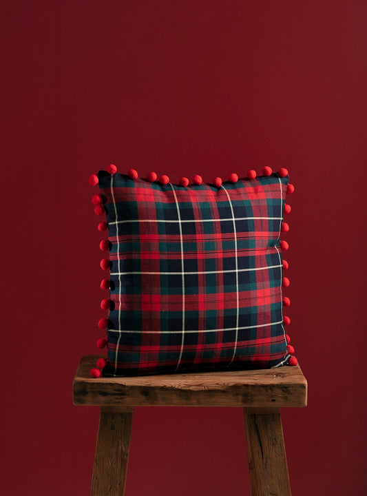 Tartan styled handmade decorative cushion for chrismas with red background
