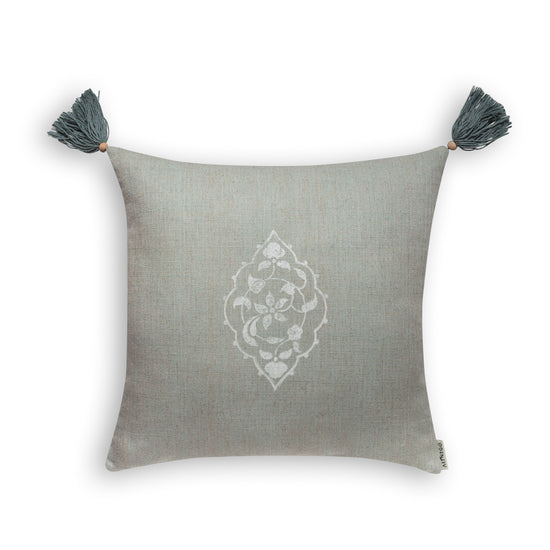 Mint green square cushion cover with white floral blockprint and tassels on white background