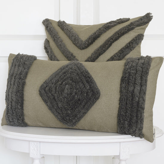 Green Bohemian Darel cushion set with square and rectangular decorative covers on white wooden table