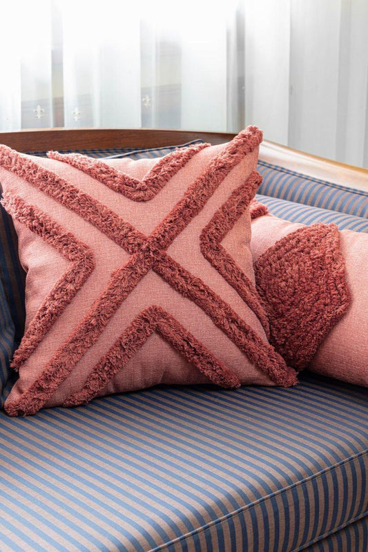 Red Bohemian Conroy square pillow cover with cotton fringe on striped blue couch