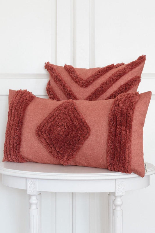 Red Bohemian Conroy pillow set with square and rectangular decorative covers on white wooden table